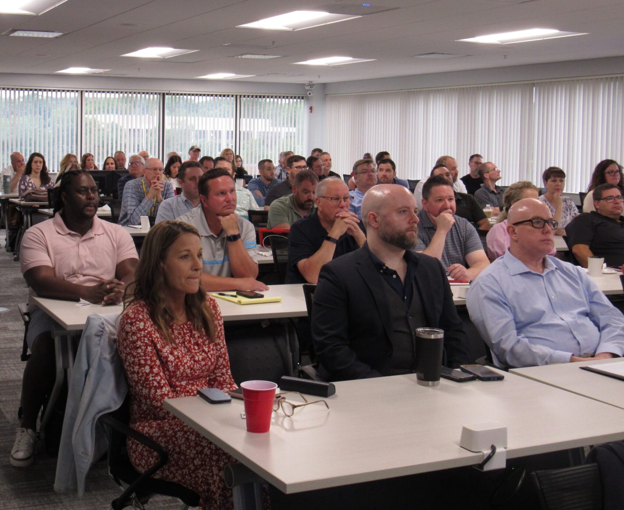 ReliabilityFirst staff members watch a presentation at a staff meeting in June 2023.